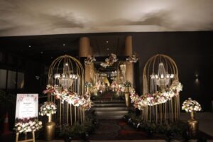 Luxurious wedding reception entrance with chandeliers and floral arches