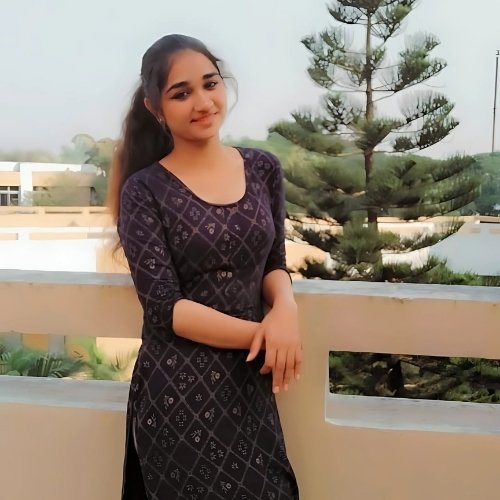 Mahi Pathak smiling in ethnic dress on balcony with trees in background