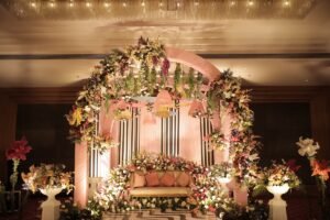 luxurious indoor floral wedding stage with arch and hanging umbrellas